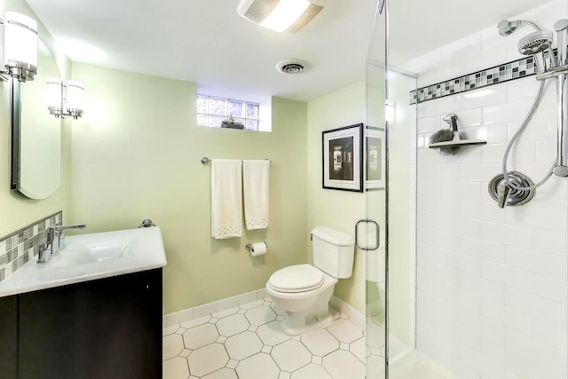 full bathroom with visible vents, baseboards, toilet, a stall shower, and vanity