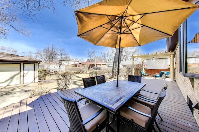 wooden deck featuring outdoor dining space, an outdoor structure, and fence