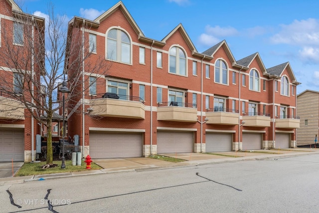 townhome / multi-family property with brick siding and an attached garage