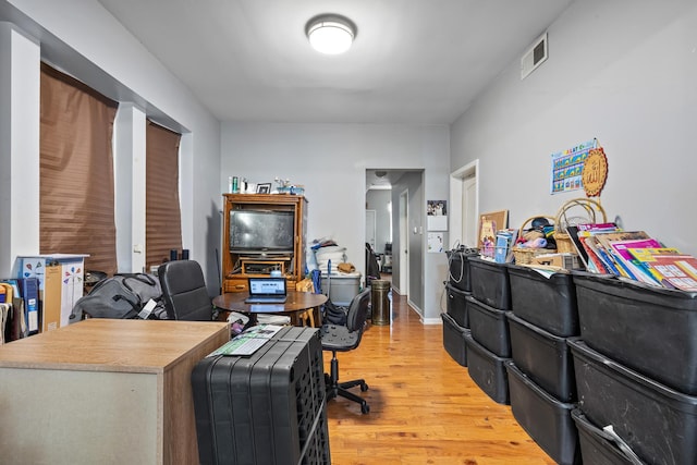 home office with hardwood / wood-style flooring