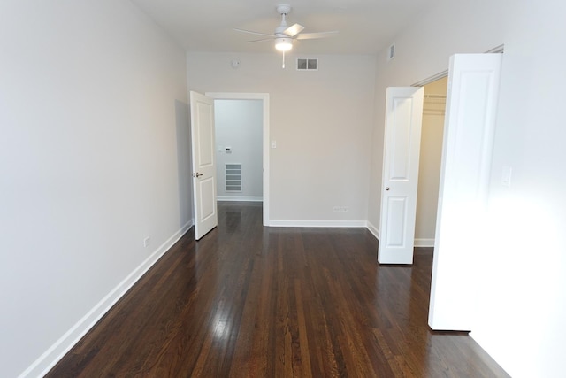 empty room with ceiling fan and dark hardwood / wood-style floors