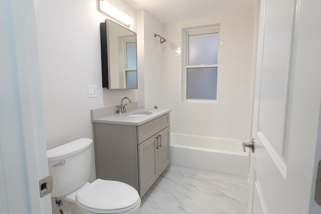 full bathroom featuring vanity, tiled shower / bath, and toilet