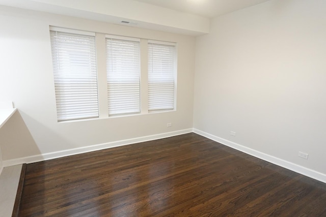 empty room featuring dark wood-type flooring