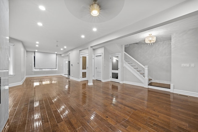 unfurnished living room with a chandelier and wood-type flooring