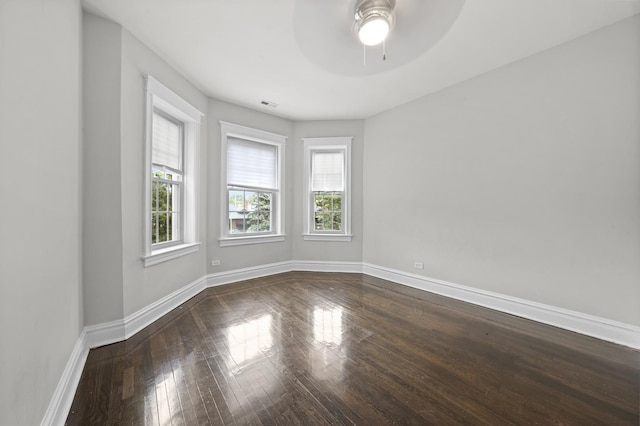 unfurnished room featuring ceiling fan and dark wood-type flooring