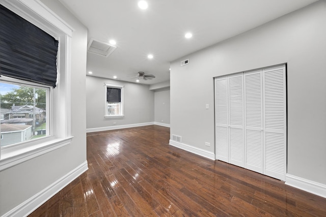 spare room featuring dark wood-type flooring and ceiling fan