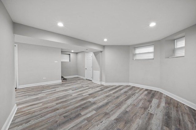 basement with light hardwood / wood-style floors