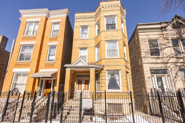 multi unit property featuring a fenced front yard