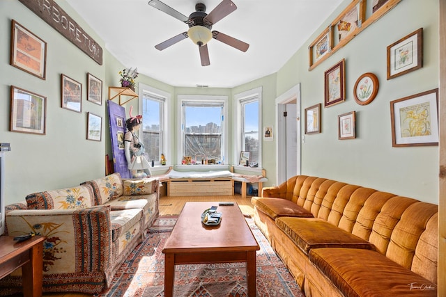 living room with hardwood / wood-style flooring and ceiling fan