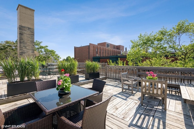 wooden deck featuring outdoor dining area