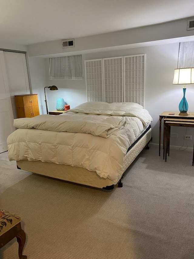 bedroom with visible vents and carpet