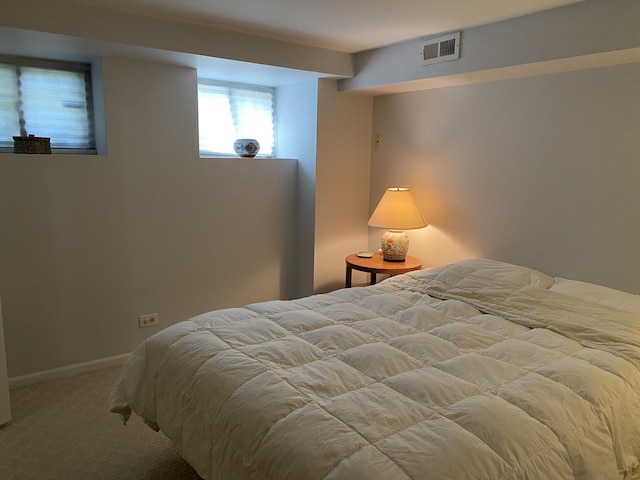 carpeted bedroom with baseboards and visible vents