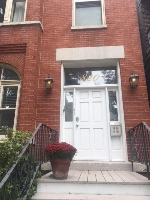 property entrance with brick siding