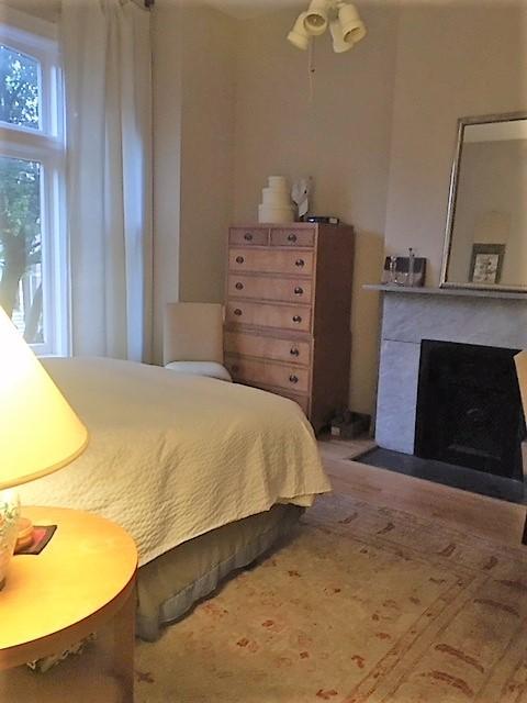 bedroom featuring a fireplace with flush hearth