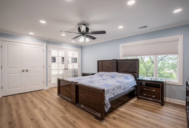 bedroom featuring visible vents, light wood-style flooring, crown molding, french doors, and recessed lighting