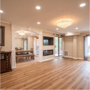 unfurnished living room featuring ornamental molding, a glass covered fireplace, recessed lighting, and wood finished floors