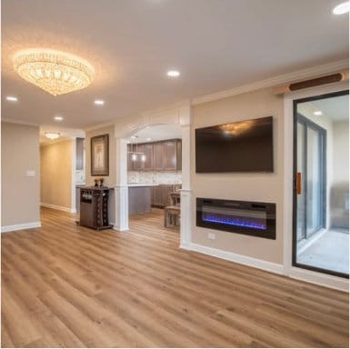 unfurnished living room with ornamental molding, recessed lighting, wood finished floors, and baseboards