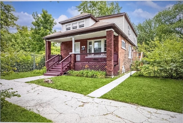 bungalow-style house with covered porch, brick siding, and a front lawn