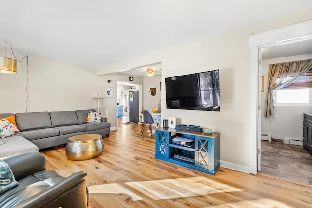 living room featuring a baseboard heating unit and wood-type flooring