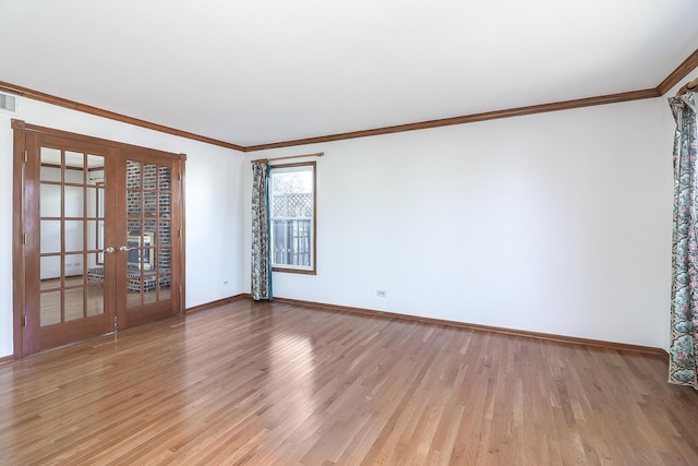 unfurnished room with light wood-style floors, french doors, ornamental molding, and baseboards