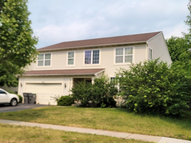 view of front of property featuring a front yard and a garage