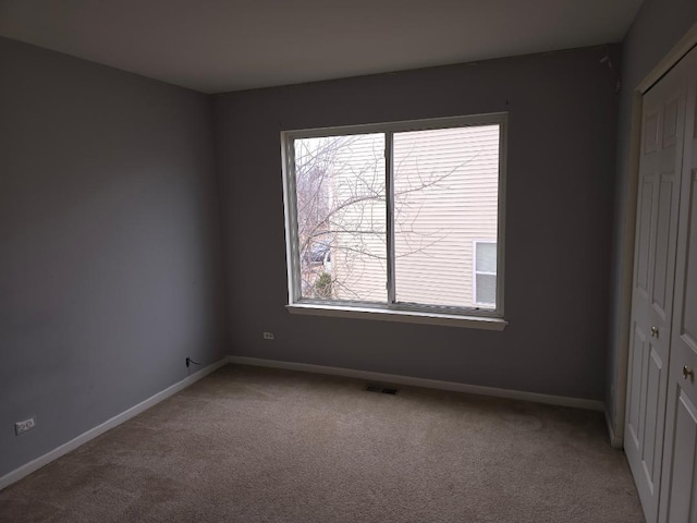 unfurnished bedroom featuring a closet and carpet flooring