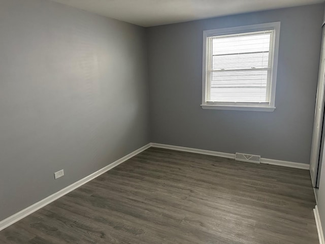 unfurnished room featuring dark hardwood / wood-style flooring