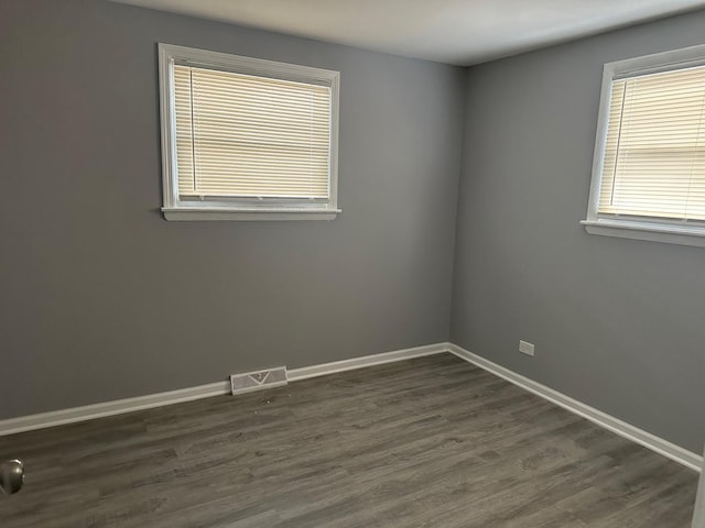 unfurnished room featuring dark hardwood / wood-style flooring