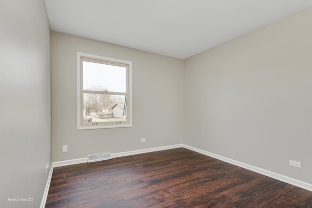 unfurnished room featuring dark wood-type flooring