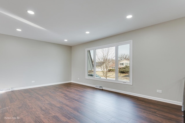 unfurnished room featuring dark wood-type flooring