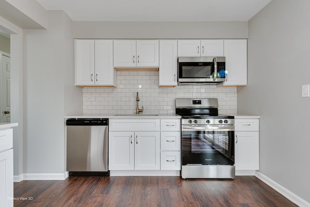 kitchen featuring sink, stainless steel appliances, and white cabinets