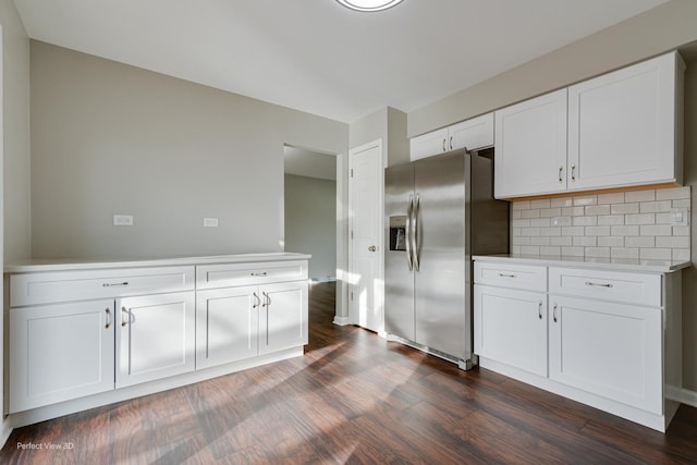 kitchen with white cabinetry, dark wood-type flooring, stainless steel fridge with ice dispenser, and decorative backsplash