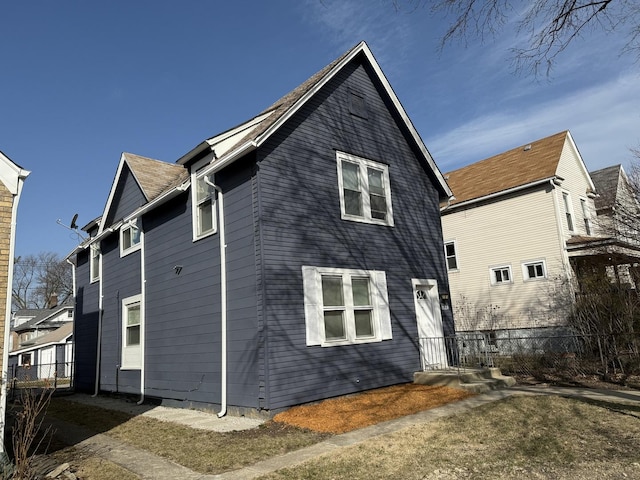 rear view of house featuring fence