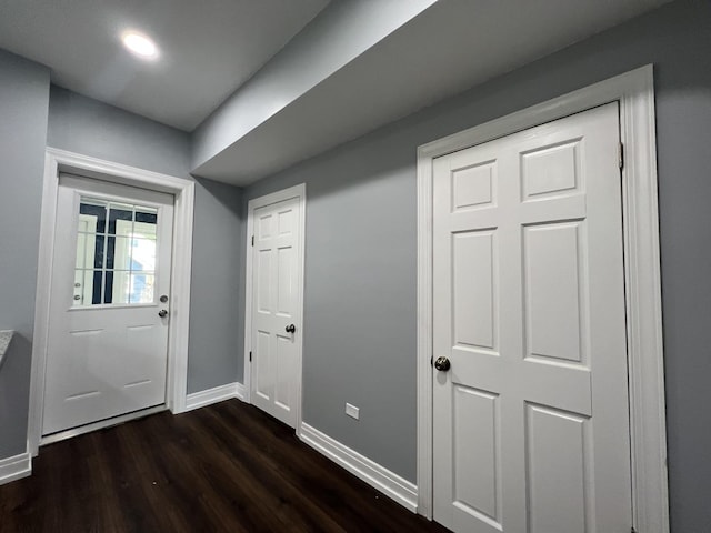 entryway with baseboards and dark wood finished floors