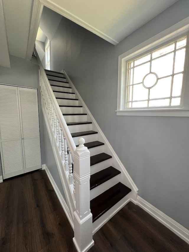 stairway with baseboards and wood finished floors