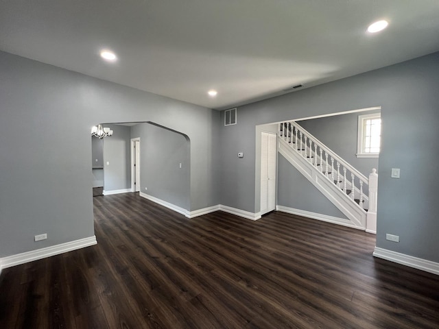 interior space featuring recessed lighting, visible vents, dark wood-type flooring, baseboards, and stairs