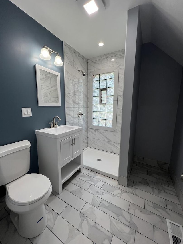 bathroom featuring marble finish floor, visible vents, toilet, a stall shower, and vanity