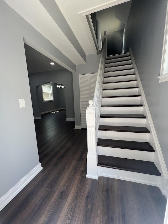 stairs with baseboards and wood finished floors