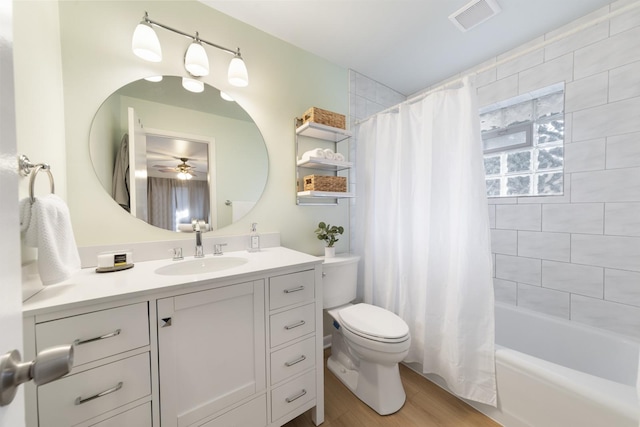 full bathroom with shower / bath combo, toilet, vanity, wood finished floors, and visible vents