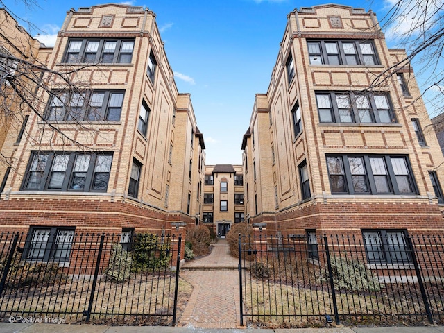 view of building exterior with a fenced front yard