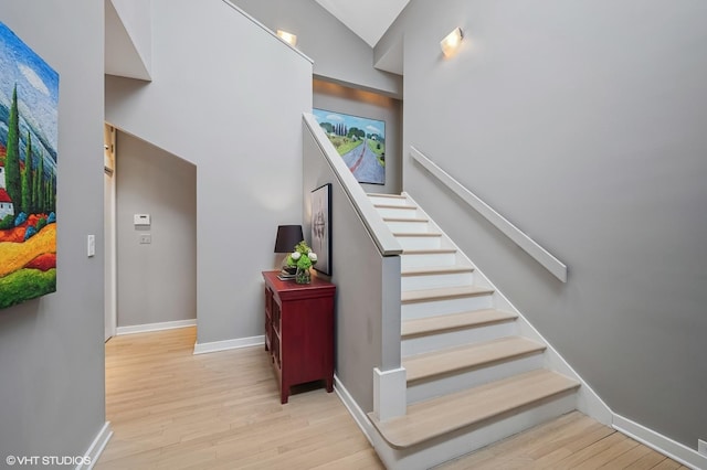 stairway featuring wood finished floors and baseboards