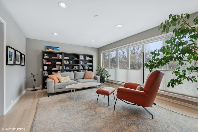 interior space with baseboards, light wood finished floors, and recessed lighting