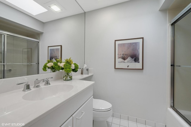 full bath with toilet, tile patterned floors, bath / shower combo with glass door, and vanity