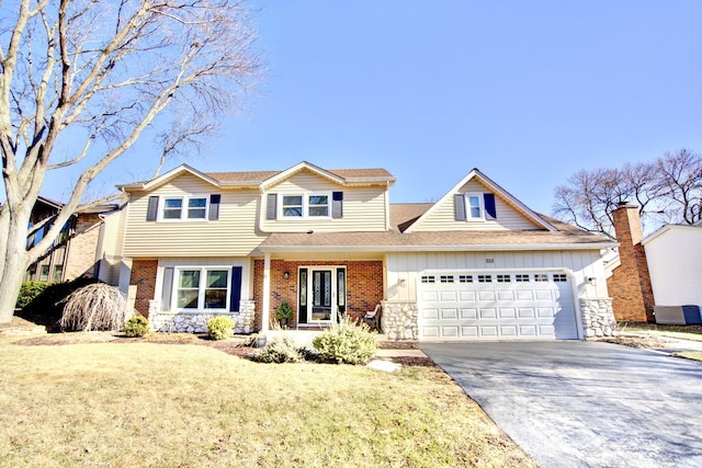 view of front of home with driveway, brick siding, an attached garage, and stone siding