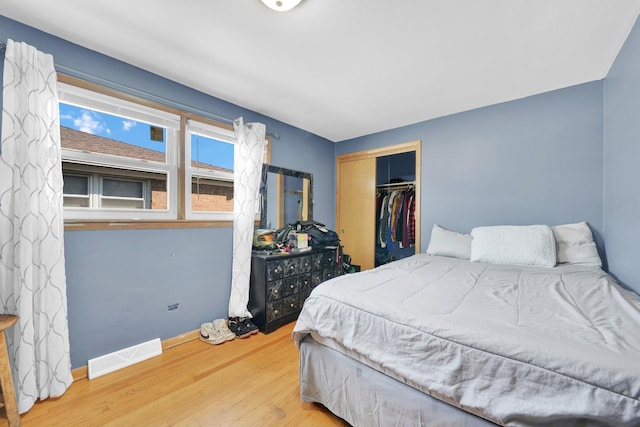 bedroom with a closet and hardwood / wood-style floors