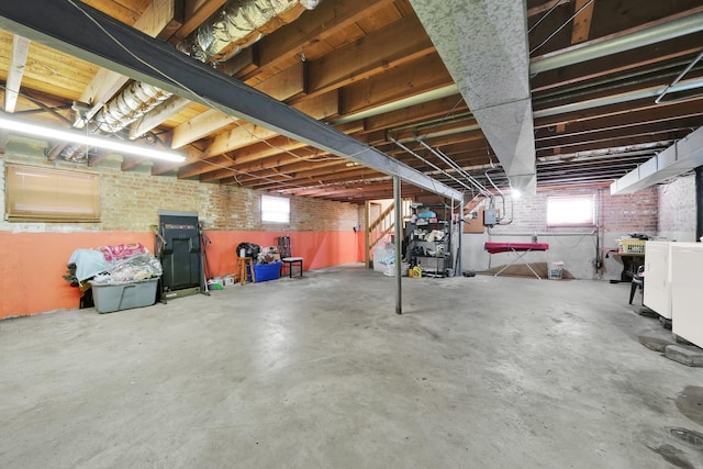 basement featuring brick wall