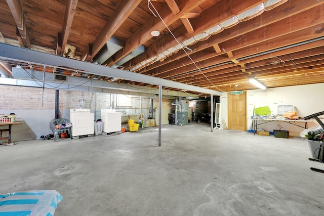 basement with washer and dryer and heating unit