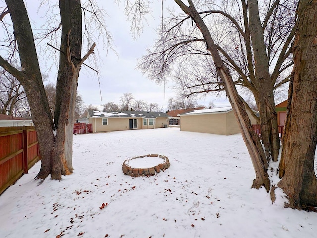 yard covered in snow with fence