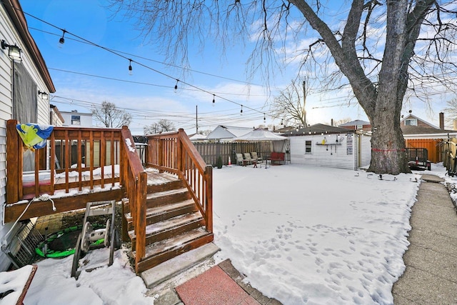 snowy yard with a wooden deck