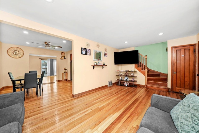 living room with hardwood / wood-style floors and ceiling fan